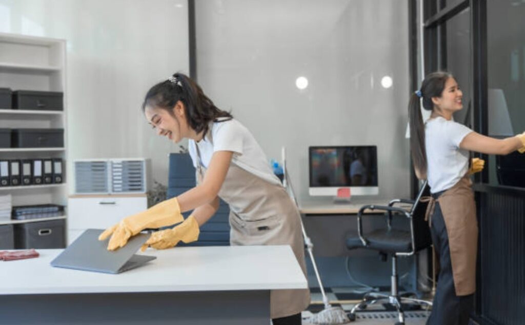 Two professional cleaners maintain a tidy Office