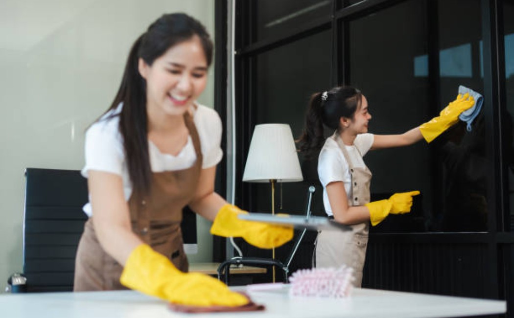 Commercial cleaning professionals disinfect the workspace