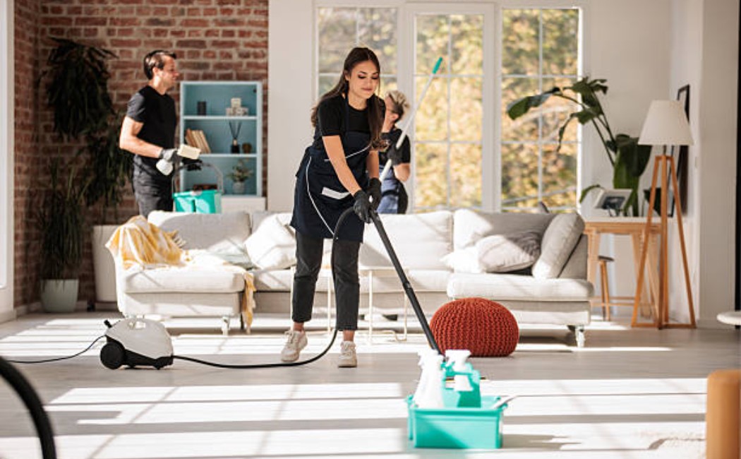 Home cleaning service team working in a spacious apartment